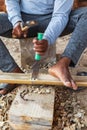Worker chiseling bamboo at a boatyard in Oman