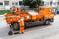 Worker of the city utility service clears storm sewer runoff from clogging