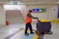 Worker clean floor with cleaning floor scrubber machine