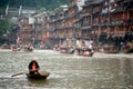 Worker clean up the river in Fenghuang ancient city.