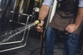 Worker cleaning brewery equipment