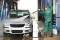 Worker cleaning car with pressured water Royalty Free Stock Photo