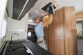 Worker Cleaning Ceiling Mounted Air Conditioning Unit Royalty Free Stock Photo