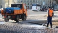 Worker cleaning the cobbled street in Sankt Petersburg, Russia