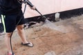 Worker cleaning dirty floor with high pressure washer Royalty Free Stock Photo