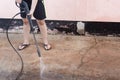 Worker cleaning dirty floor with high pressure washer Royalty Free Stock Photo