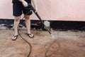 Worker cleaning dirty floor with high pressure washer Royalty Free Stock Photo