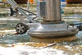 Worker cleaning dirty floor with machine cleaner Royalty Free Stock Photo