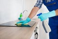 Worker Cleaning Electric Hob Royalty Free Stock Photo