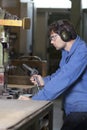 Worker cleaning fabric mashine Royalty Free Stock Photo