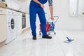 Worker Cleaning Floor In Kitchen Room Royalty Free Stock Photo