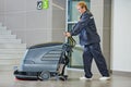 Worker cleaning floor with machine Royalty Free Stock Photo