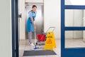 Worker Cleaning Floor With Mop Royalty Free Stock Photo