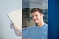 Worker Cleaning Glass With Squeegee Royalty Free Stock Photo