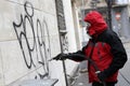 Worker cleaning graffiti