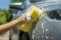 Worker cleaning a gray car outdoors Royalty Free Stock Photo