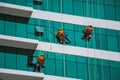 Worker cleaning high tower in big city