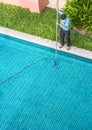 Worker cleaning the pool.