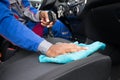 Worker Cleaning Seat Inside The Car