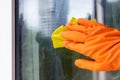 A worker of the cleaning service of offices and apartments washes the window from dust Royalty Free Stock Photo