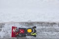 Worker cleaning snow on the sidewalk with a snowblower. Wintertime