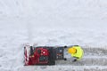 Worker cleaning snow on the sidewalk with a snowblower. Wintertime