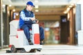 Worker cleaning store floor with machine Royalty Free Stock Photo