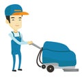 Worker cleaning store floor with machine. Royalty Free Stock Photo