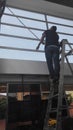 worker cleaning windows