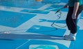 Worker cleans the bottom of a large blue pool