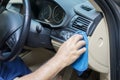 Worker cleans the car dashboard with cloth Royalty Free Stock Photo