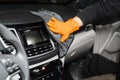 Worker cleans cars using microfiber cloth to dry the dashboard during the process of hand-drying the interior of the car Royalty Free Stock Photo