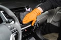 Worker cleans cars using microfiber cloth to dry the dashboard during the process of hand-drying the interior of the car Royalty Free Stock Photo