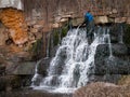 Worker cleans the old waterfall