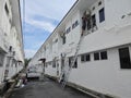 Worker climbed high up to the second storey building servicing the outlet air condition unit