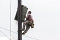 Worker climbing on Electrical concrete pole transmission line