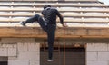 Worker climbs the boards on the roof Royalty Free Stock Photo