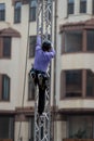 Worker climbs a scaffold throug