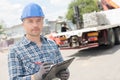 Worker with clipboard in front truck Royalty Free Stock Photo