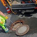 Worker closes a manhole cover in the street