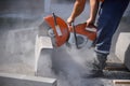 A worker sawed a concrete block.