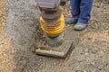 Worker compacting the sand bedding with mechanical rammer Royalty Free Stock Photo