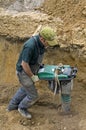 Worker compacting sand with vibrating plate tamper Royalty Free Stock Photo