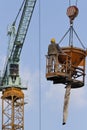 A worker in a concrete bucket