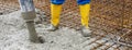 worker is concreting the floor of new built huose.