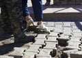 A worker  lifts paving slabs. Royalty Free Stock Photo