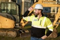 Worker at construction site. Builder in hardhat. Construction man with helmet. Worker at construction with helmet