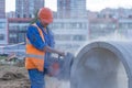 Worker cuts the concrete ring