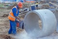 Worker cuts the concrete ring