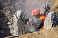 Worker at the construction site cuts concrete